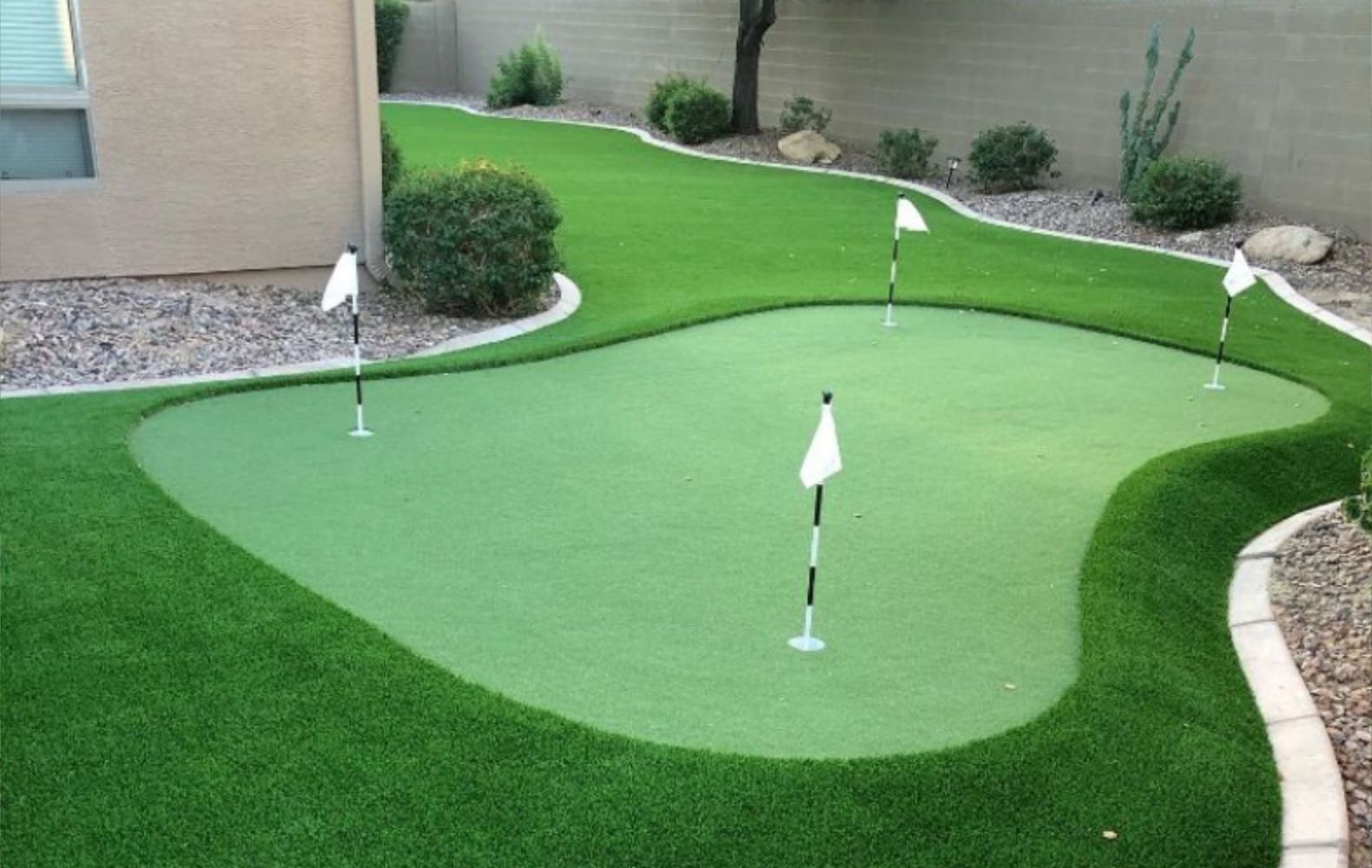 Putting green with golf artificial grass in a landscaped courtyard
